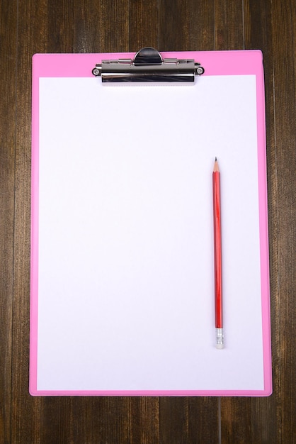 Clipboard on wooden background