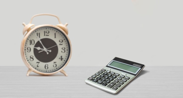 Clock and calculator on the table work and time concept