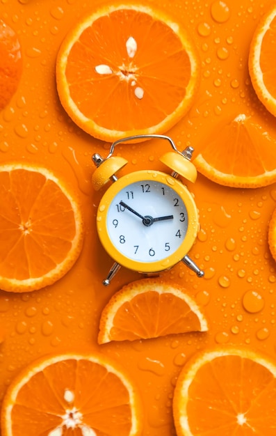 Clock and citruses summer time concept Selective focus