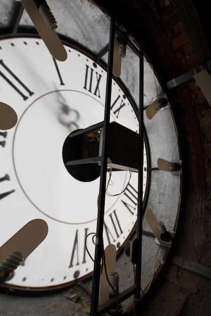 Clock face of old wall clock  mechanism inside vertical close up