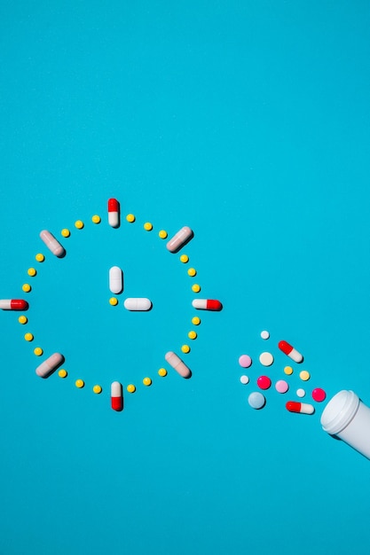 Photo clock made from colorful pills as a concept of taking medicine in time by prescription