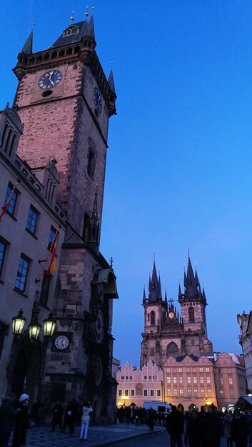 Clock tower in city against clear sky