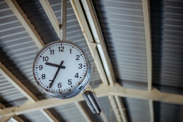 Clock in the train station on background