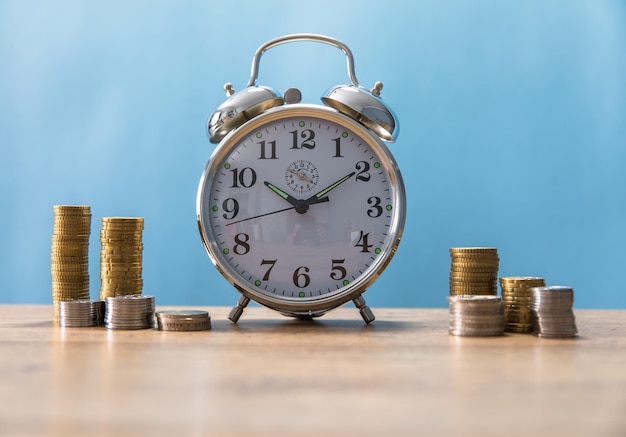 Clock with coins on the table