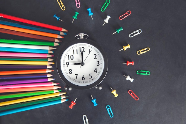 Clock with pencils and stationary