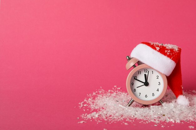 A clock with a santa hat with a new year's decoration