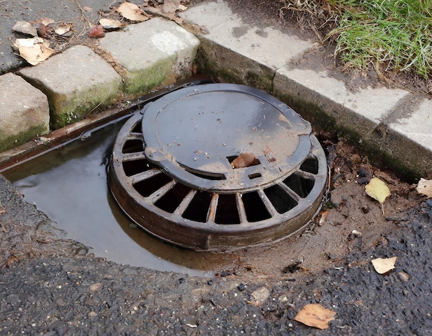 Photo a clogged drain cover is sitting on the ground