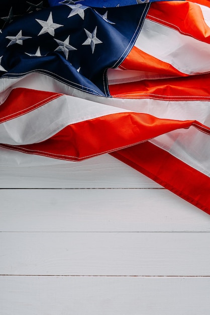 Close american flag on a white wooden background with place for text