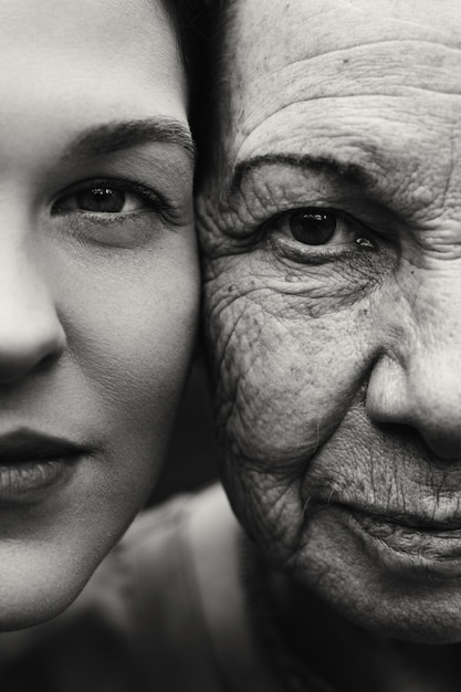 Close face of grandmother and granddaughter They look at the camera