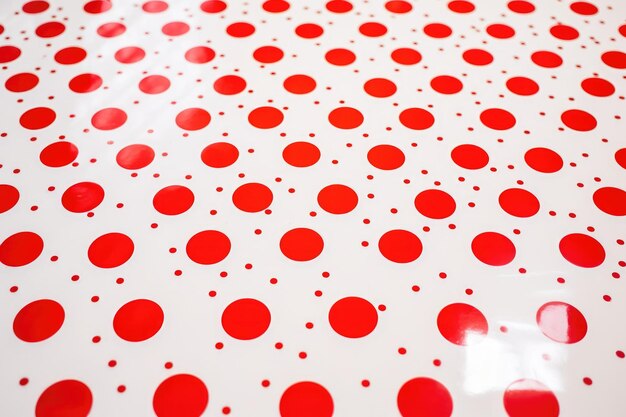 Close focus of modern red on white polka dot ceramic tile