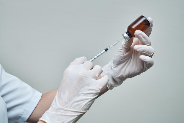 Close of Nurse hands preparing vaccine dose with copy space