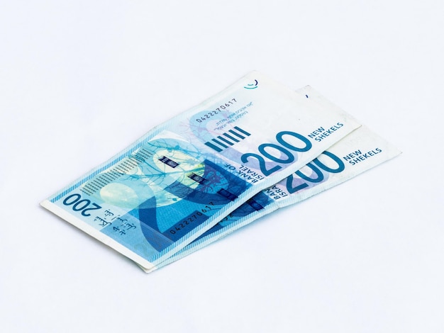 Close-up of 200 israeli shekel notes on white background