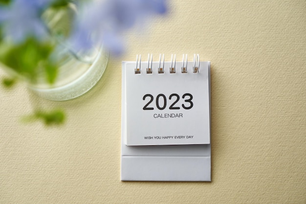 Close up of 2023 desk calendar and flower