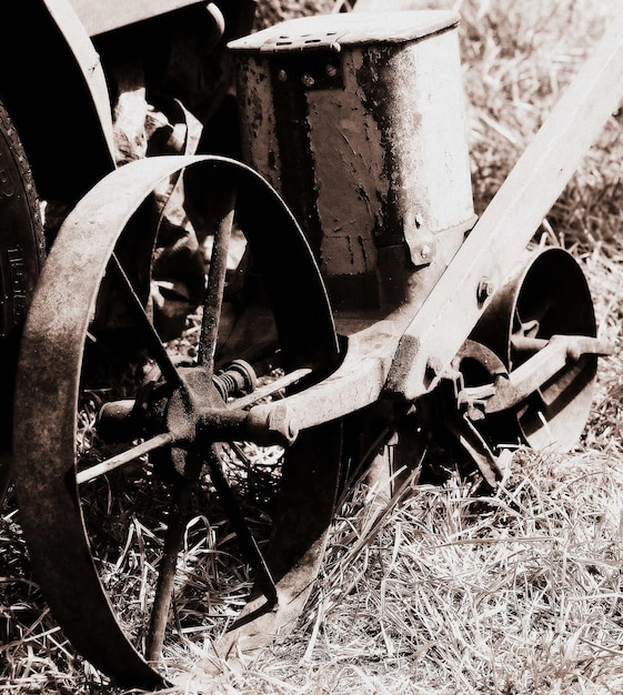 Photo close-up of abandoned seed spreader on field