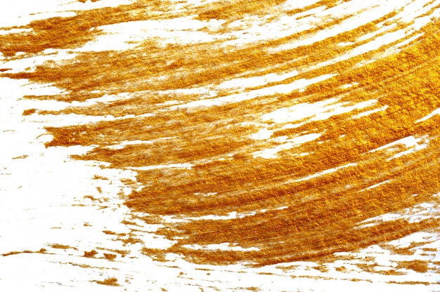 Photo close up abstract gilded background with acrylic paint brush