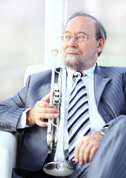 Close up.adult male musician sitting in a chair.