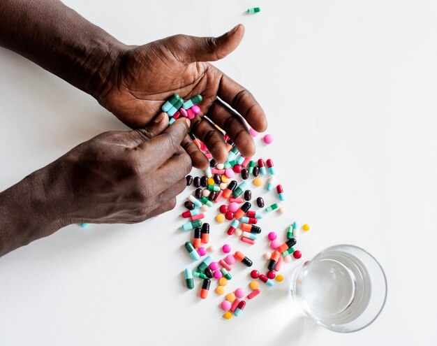 Close up of an adult taking medication