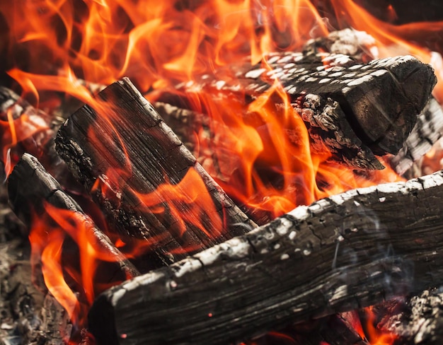 Close up of the aflame wood in bonfire