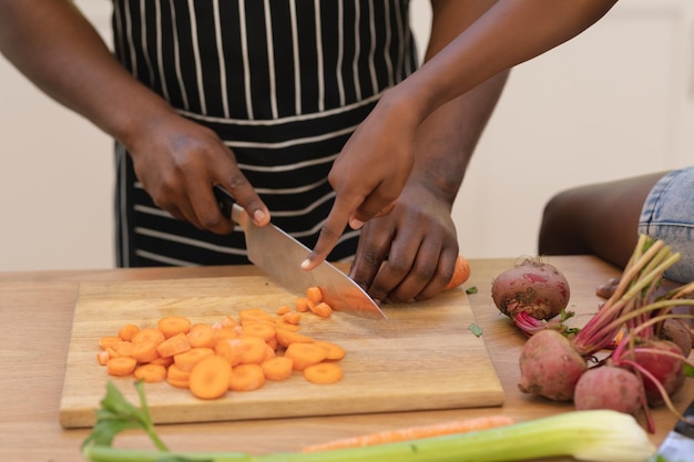 Close up of african american father teaching daughter cooking in the kitchen