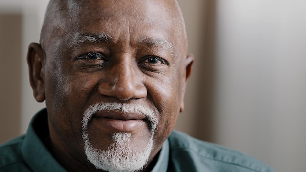 Close up african elderly male business worker portrait indoors in office old mature senior american