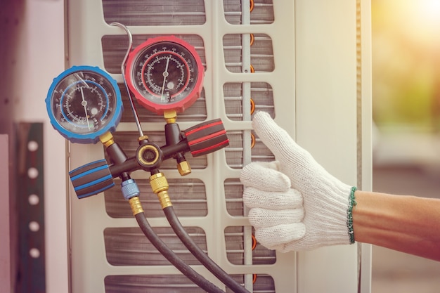 Close up of Air Conditioning Repair, repairman on the floor fixing air conditioning system