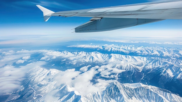 close up airplane wings over the air with beautiful mountain and blue sky background