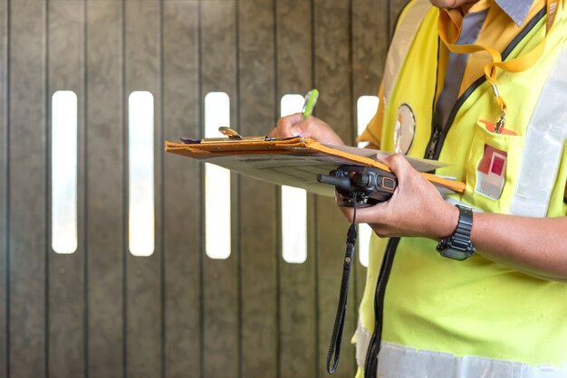 Close up airport staff checking passenger before boarding.