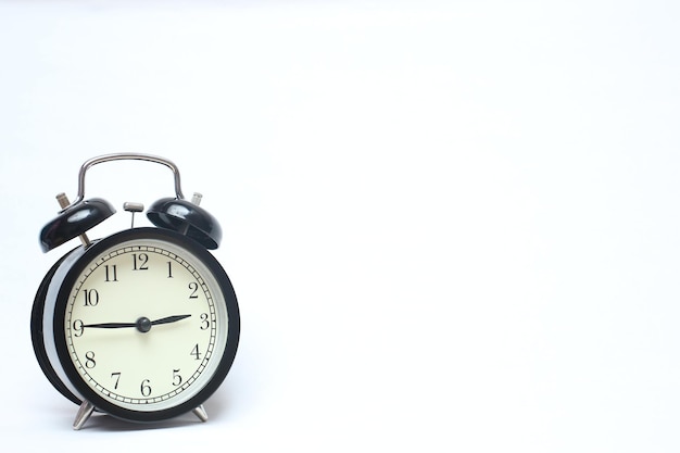 Photo close-up of alarm clock on white background