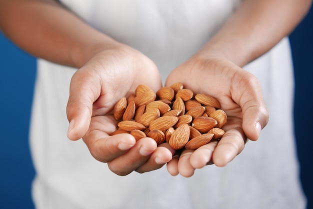 Close up of almond nuts on mans hand