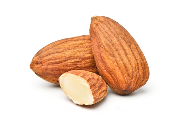 Photo close-up almond seeds  with cut in half isolated on white.