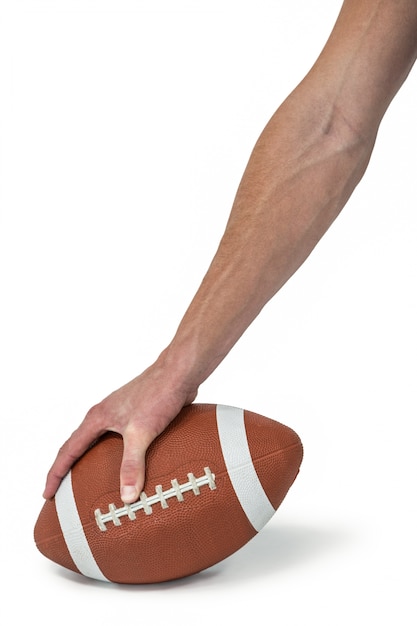 Photo close-up of american football player placing the ball