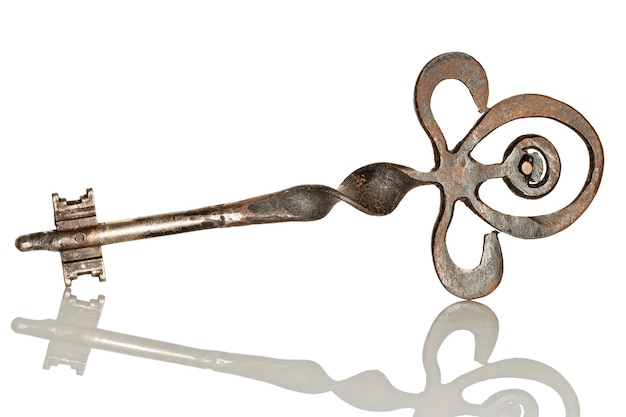 Close-up of antique key against white background