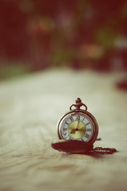 close-up of antique pocket watch on table
