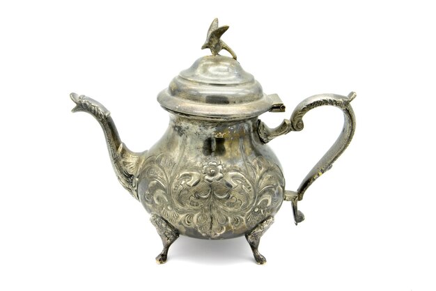 Photo close-up of antique teapot against white background