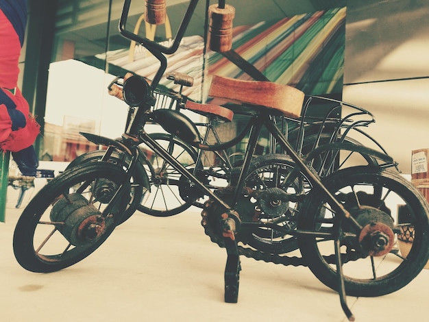 Photo close-up of antique toy bicycle on floor