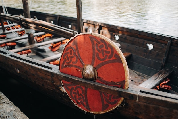 Close up on antique Viking ship on the river Old boat