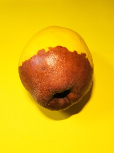 Close-up of apple against yellow background