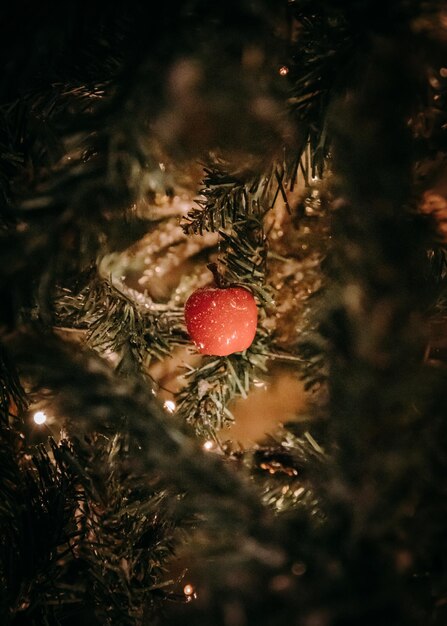 Close-up of apple ornament on christmas tree