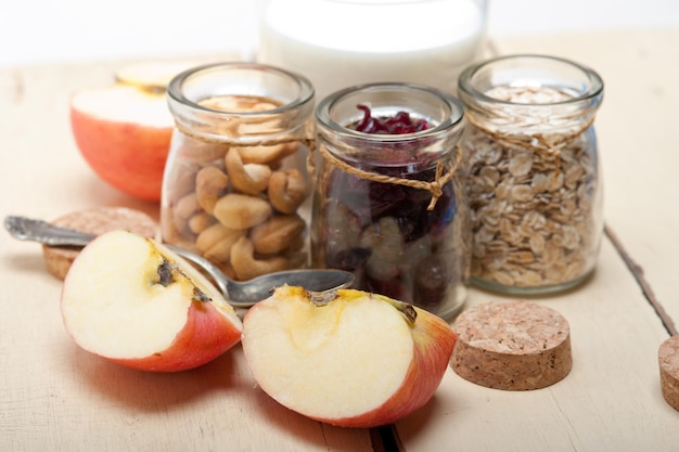close-up of apple slices by dried fruits in jars on table