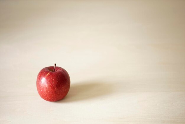 Close-up of apple on table against white background