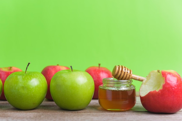 close-up of apples on table against green background