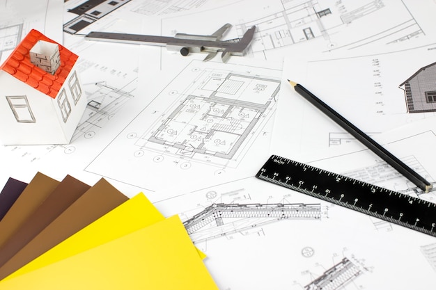 Close-up of Architect engineer drawing plan with architect equipment. Paper architectural drawings