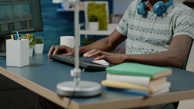 Close up of architect using keyboard and computer