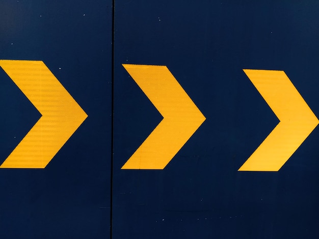 close-up of arrow sign on road