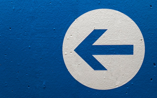 Close-up of arrow symbol on wall