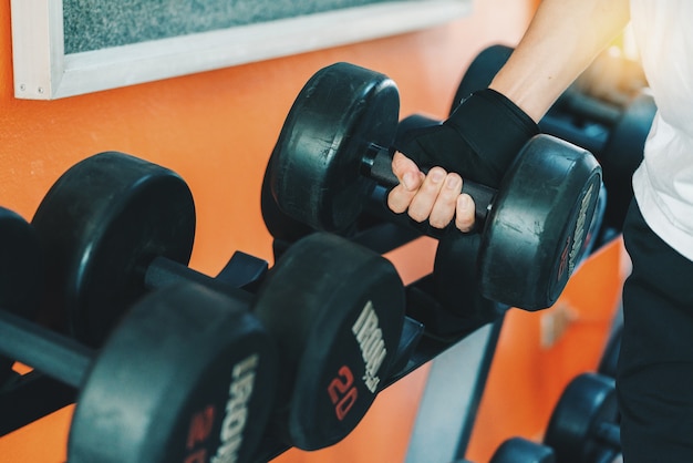 Close up of  asia man hand holding dumbbell 