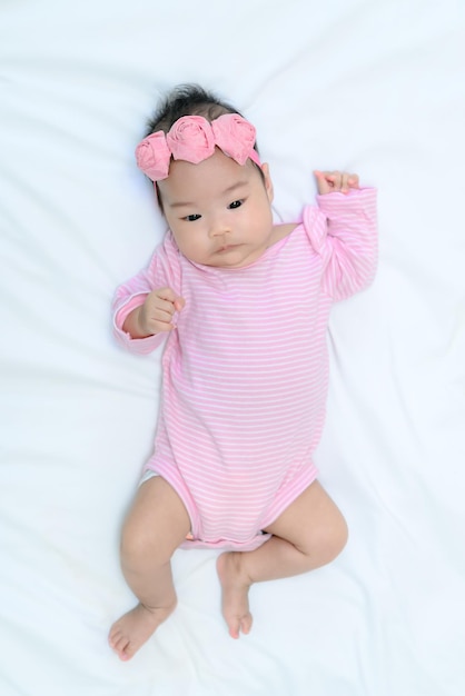 Close up asian baby girl cry on white wool carpet