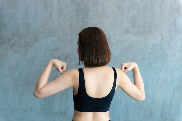 Close up asian beautiful sport girl on wall of gymThailand love healthSlim woman workout concept