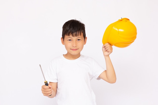 Close-up of an Asian boy wearing a hardhat smiling and looking at camera, standing isolated on white surface