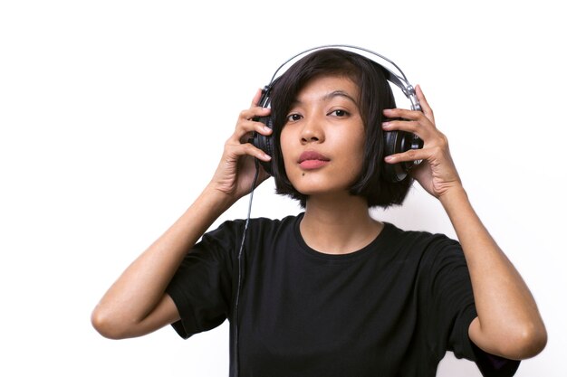 Close-up asian woman with headphones enjoying music on white space